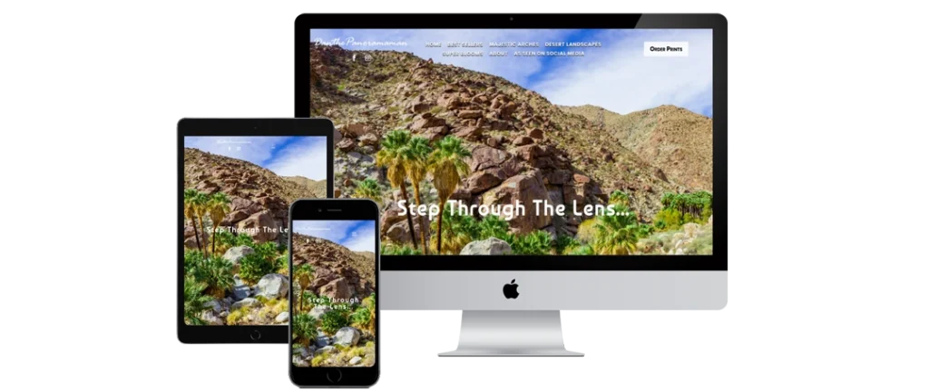 A computer monitor, tablet, and smartphone display the same website with a desert landscape image, featuring rocky hills and palm trees, and the text 