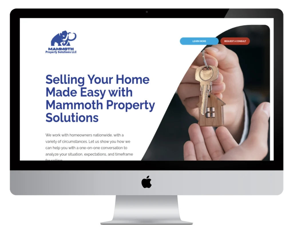 A computer monitor displays a website for Mammoth Property Solutions, featuring someone handing over house keys and text that reads 