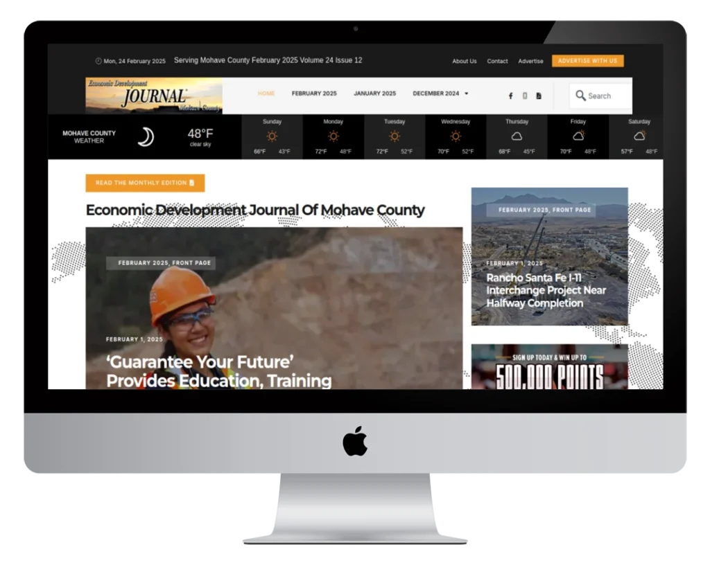 A desktop computer displaying the homepage of the Mohave County Journal website, featuring news headlines, date, weather, navigation menu, and a main article about education and training opportunities.