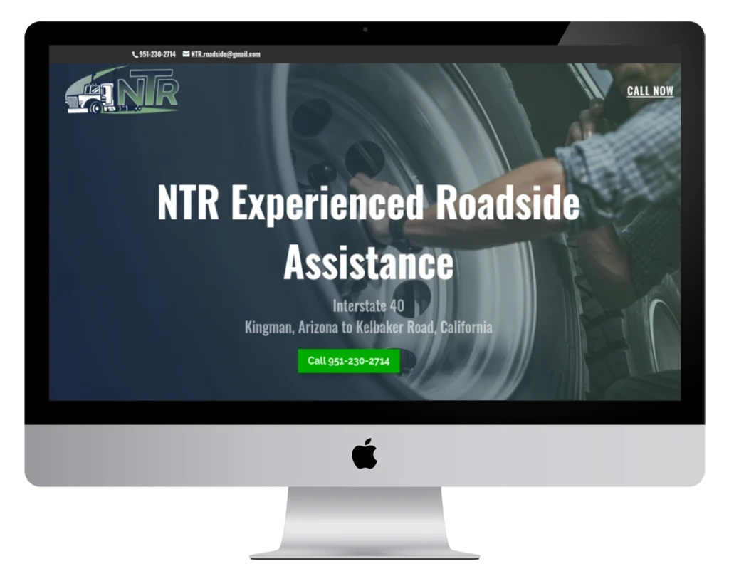 A computer monitor displays a website for NTR Experienced Roadside Assistance, showing contact info, a large tire, and a green call button. Service area includes Interstate 40 in Kingman, Arizona to Kelbaker Road, California.