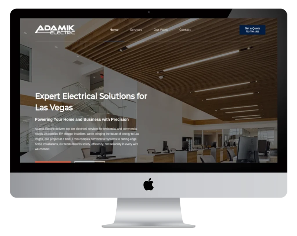 A desktop monitor displays the homepage of Adamik Electric's website, featuring a modern office interior, navigation menu, company logo, and text promoting electrical services in Las Vegas.