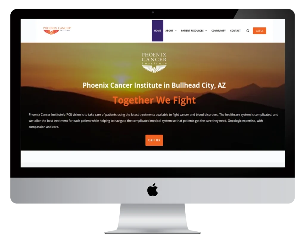A computer screen displays the homepage of Phoenix Cancer Institute, featuring a sunset background, navigation menu, and text describing the institute’s mission in Bullhead City, AZ.