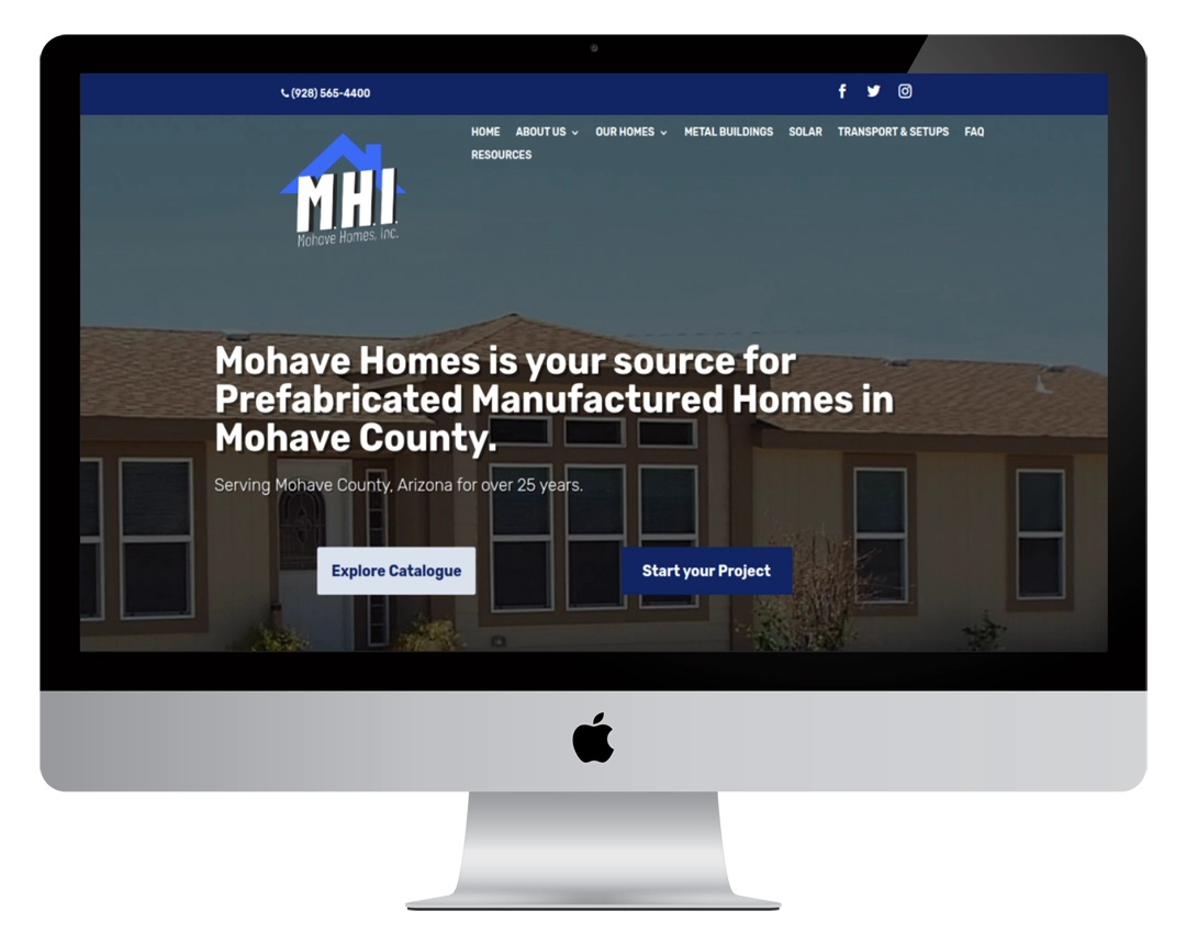 A computer monitor displays the Mohave Homes website homepage, featuring the company logo, navigation menu, and text stating they provide prefabricated manufactured homes in Mohave County, Arizona.