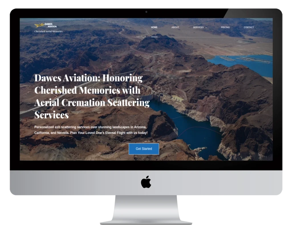 A computer monitor displays a website for Dawes Aviation, offering aerial cremation scattering services. The homepage features a mountainous landscape with water and text describing the services, plus a 