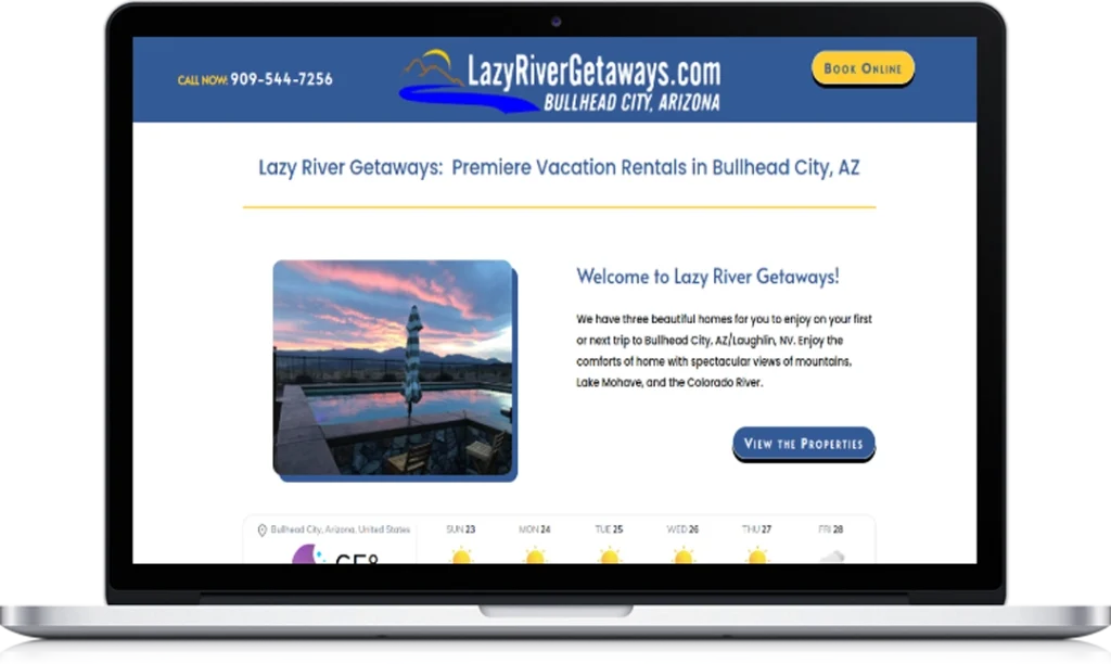 A laptop screen displays the Lazy River Getaways website, showing a sunset image above water, contact info, and text welcoming users to vacation rentals in Bullhead City, Arizona, with a “View the Properties” button.