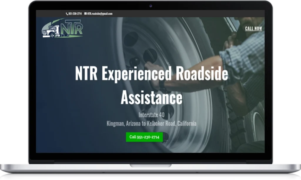 A laptop screen displays the NTR Experienced Roadside Assistance website, featuring a large tire, contact numbers, and a green call button, with service offered from Kingman, Arizona to Kelbaker Road, California.