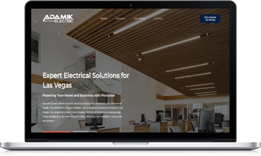 A laptop displays the homepage of Adamik Electric’s website, featuring a modern office interior, navigation menu, company logo, and a highlighted blue button with a phone number for quotes in the top right corner.