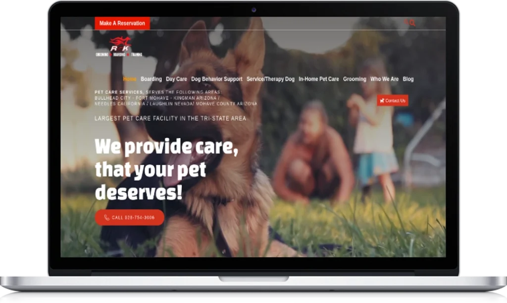 A laptop screen displays a pet care website featuring a blurred background image of a German Shepherd dog with a child sitting on the grass. The site offers pet care services and includes a “Make a Reservation” button.