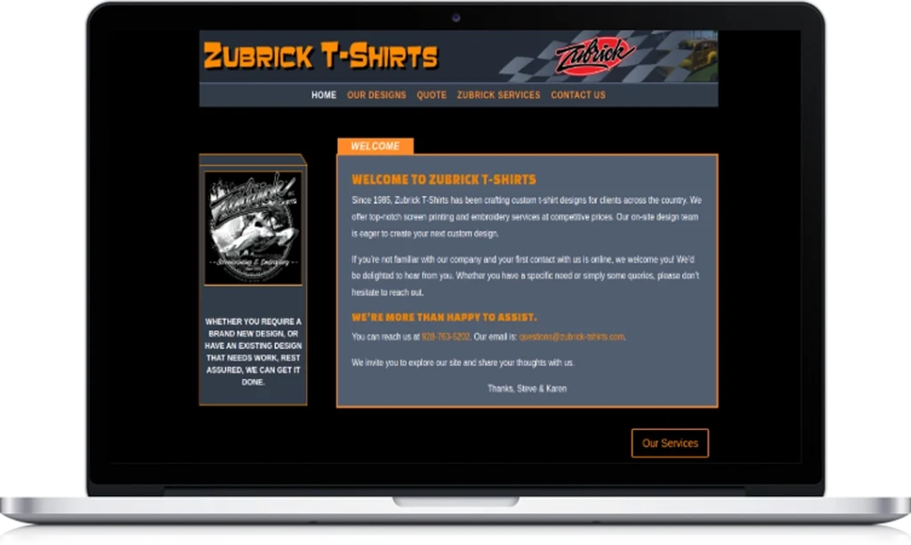 A laptop screen displays the Zubrick T-Shirts website featuring a black and orange color scheme, a welcome message, service details, and a navigation menu with options like “Our Designs” and “Contact Us.”.