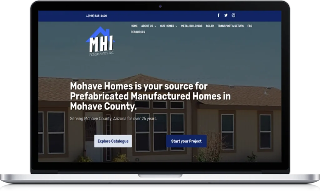 A laptop screen displays the Mohave Homes Inc. website featuring a banner that reads, 