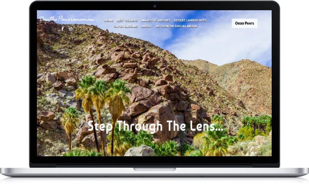 A laptop screen displays a website with a photo of a rocky desert landscape and palm trees. White text on the image says, 