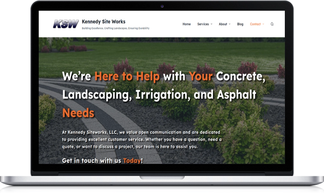 A laptop displays the Kennedy Site Works website homepage, featuring text about concrete, landscaping, irrigation, and asphalt services, with images of landscaped bushes and a navigation menu at the top.