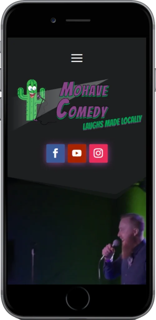 A smartphone screen displays the Mohave Comedy website homepage, featuring a cactus logo, slogan 