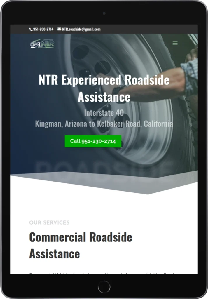 A tablet displaying a website for NTR Experienced Roadside Assistance, featuring a large tire image, contact details, a green call button, and service information for Kingman, AZ to Kelbaker Road, CA on Interstate 40.