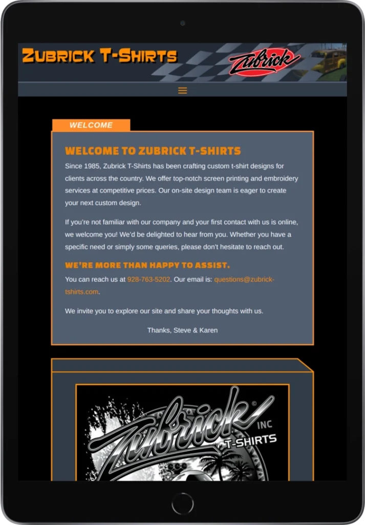 A tablet displays the homepage of Zubrick T-Shirts, featuring a welcome message, contact information, the company logo, and a black-and-white graphic of a Zubrick T-Shirts design.