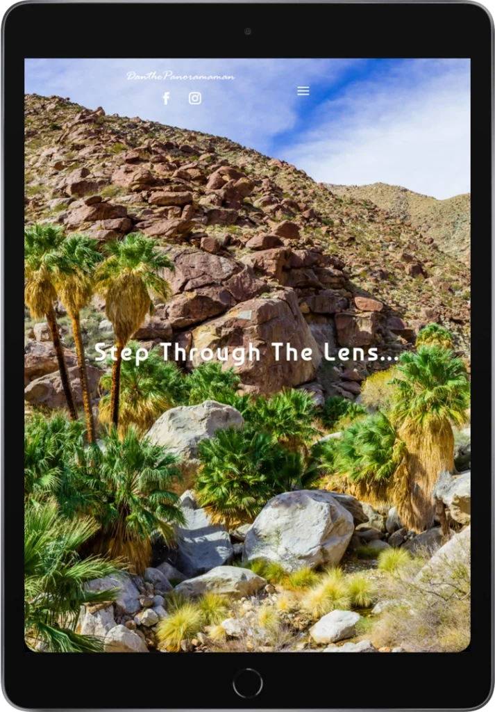 A tablet screen displays a website with a desert landscape of rocky hills, palm trees, and scattered bushes. White text in the center reads, 