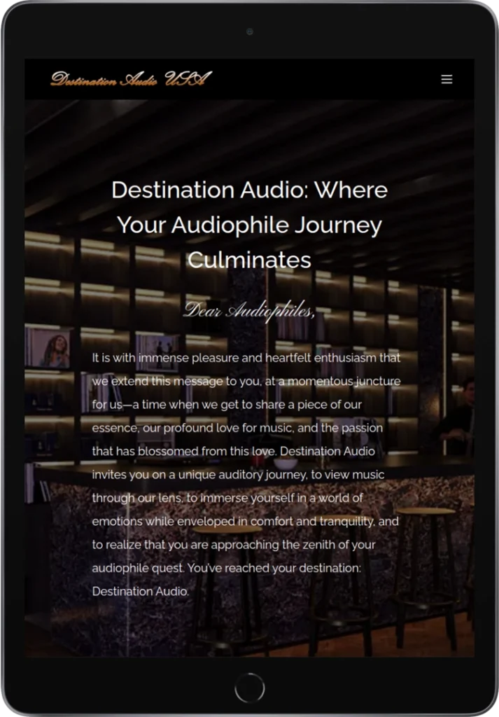 A tablet displays the homepage of Destination Audio USA, featuring a dark background with a bar and shelves, gold logo and text, and a welcome message titled 